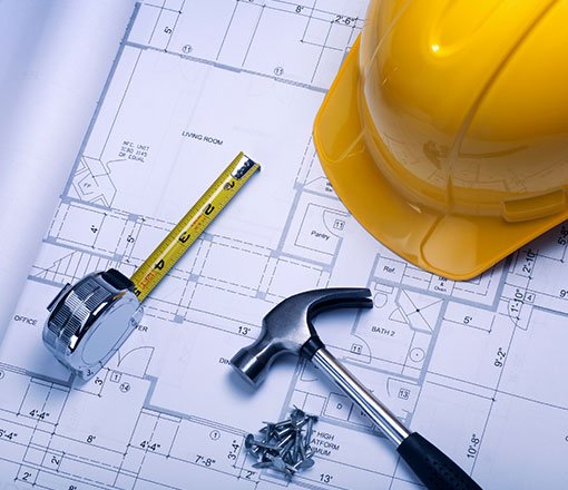 Hammer, hard hat, nails, tape measurer and a plan.